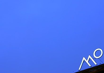 a blue sky with a sign on top of it
