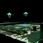 A glowing green circuit board with a central processor.