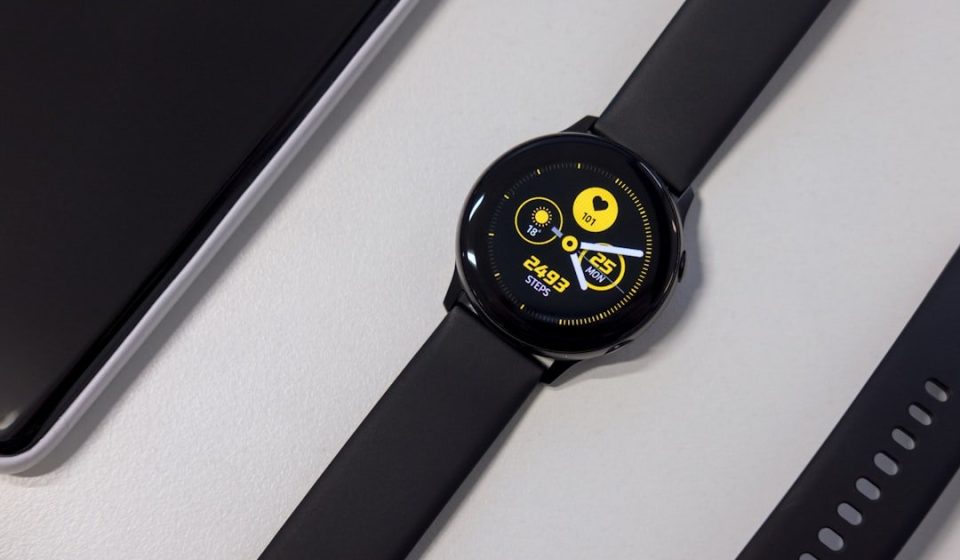 turned-on black smartwatch on white surface