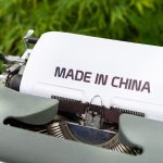 white and black typewriter on green grass during daytime