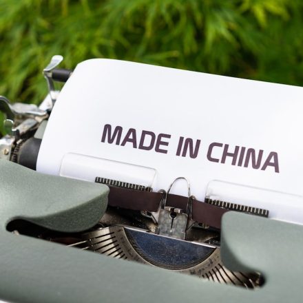 white and black typewriter on green grass during daytime