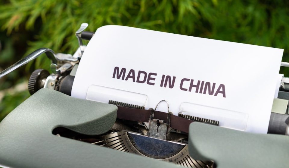 white and black typewriter on green grass during daytime