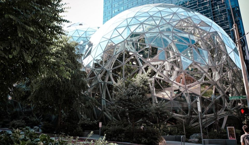 Modern glass spheres building with lush green trees
