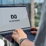Person typing on laptop with ai gateway logo.