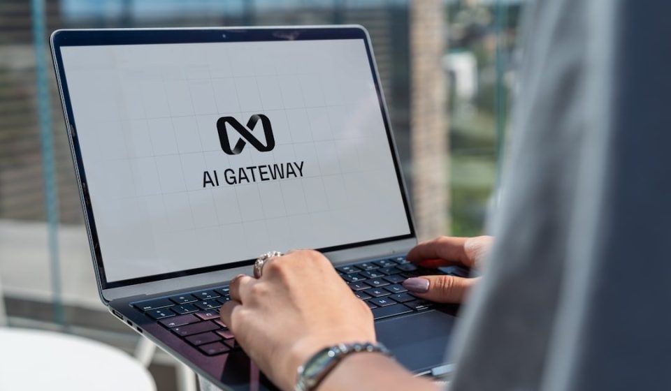 Person typing on laptop with ai gateway logo.