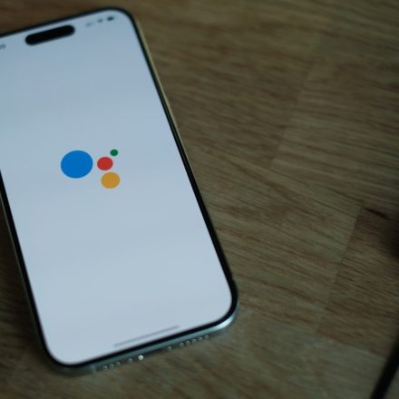 A cell phone sitting on top of a wooden table