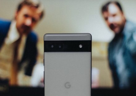 a close up of a cell phone near a television