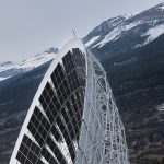 Modern solar panel structure against snowy mountains