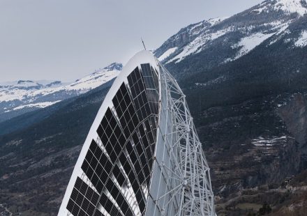 Modern solar panel structure against snowy mountains