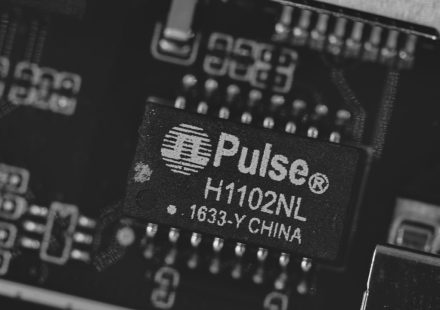 Close-up of a pulse h1102nl electronic component.