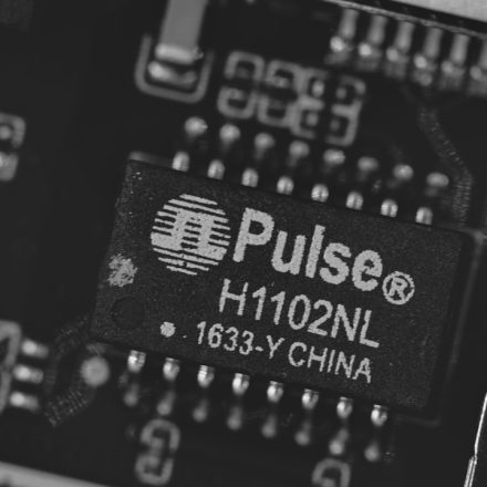 Close-up of a pulse h1102nl electronic component.