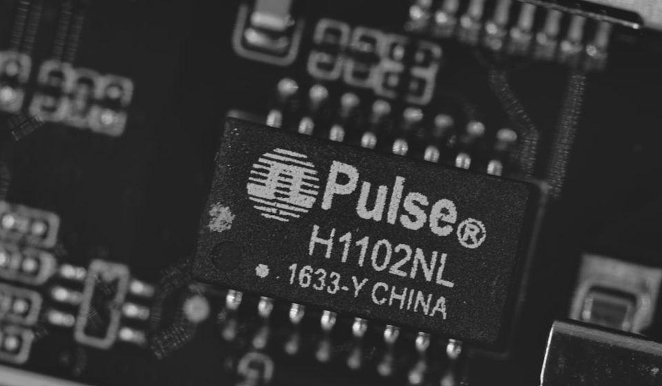Close-up of a pulse h1102nl electronic component.
