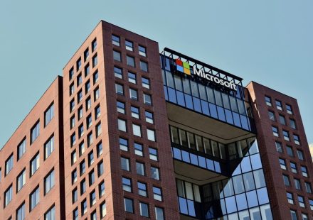 a tall brick building with windows and a sky background