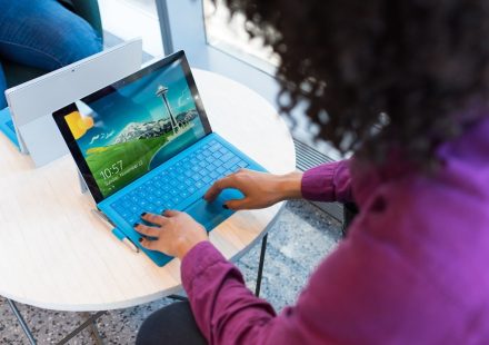 woman in purple sweater using laptop