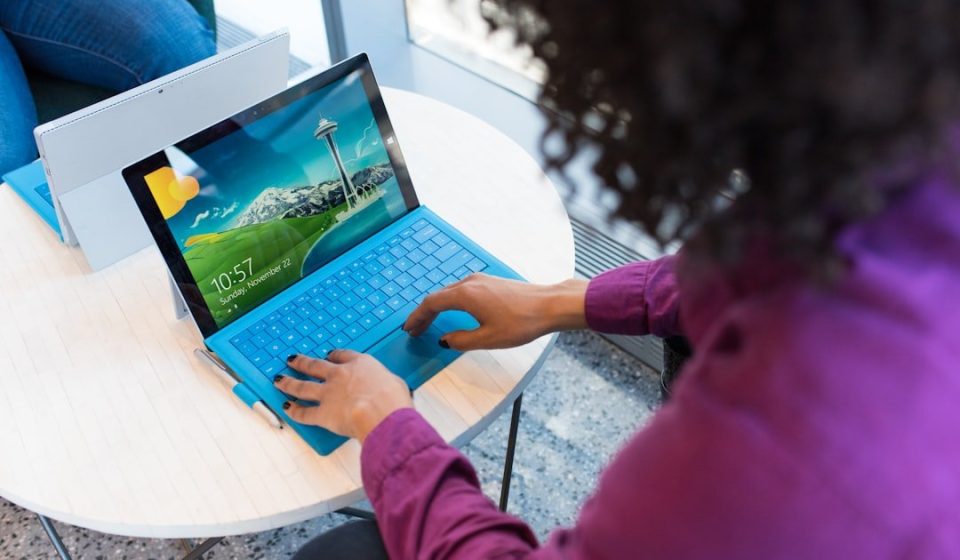 woman in purple sweater using laptop