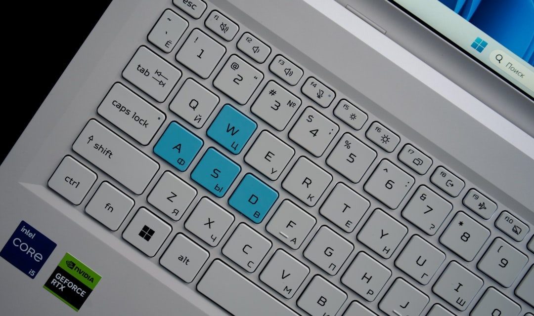 Close-up of a laptop keyboard with wasd keys highlighted.