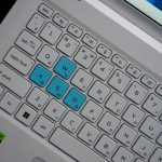 Close-up of a laptop keyboard with wasd keys highlighted.