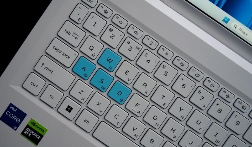 Close-up of a laptop keyboard with wasd keys highlighted.