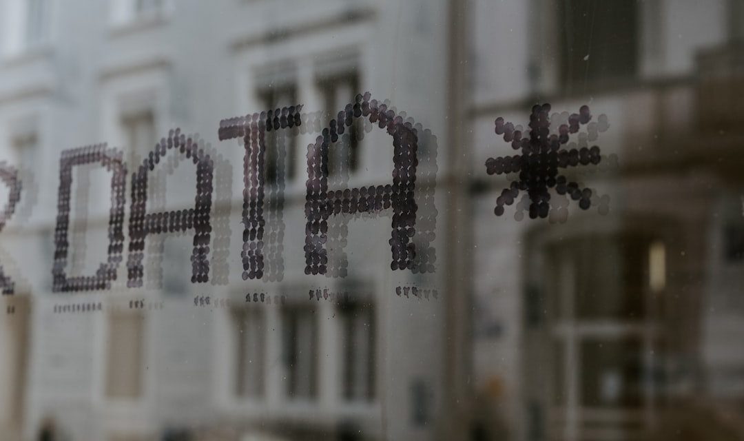 The word DATA and a star symbol stenciled in dark dots on glass