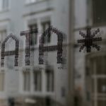 The word DATA and a star symbol stenciled in dark dots on glass