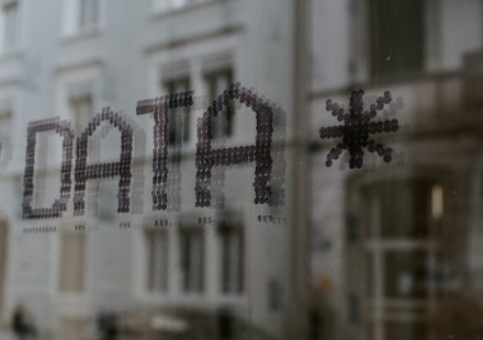 The word DATA and a star symbol stenciled in dark dots on glass