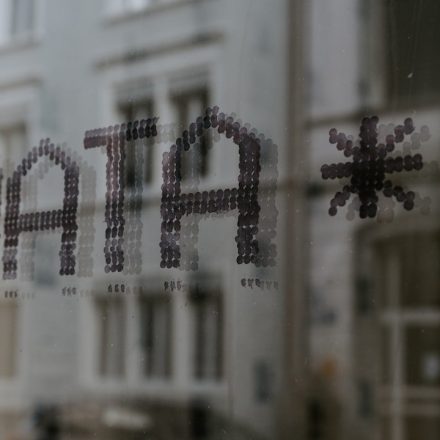 The word DATA and a star symbol stenciled in dark dots on glass