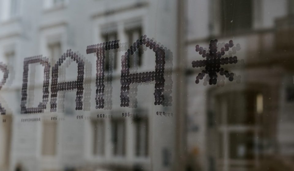 The word DATA and a star symbol stenciled in dark dots on glass
