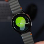 A close up of a person holding a smart watch