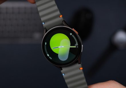 A close up of a person holding a smart watch