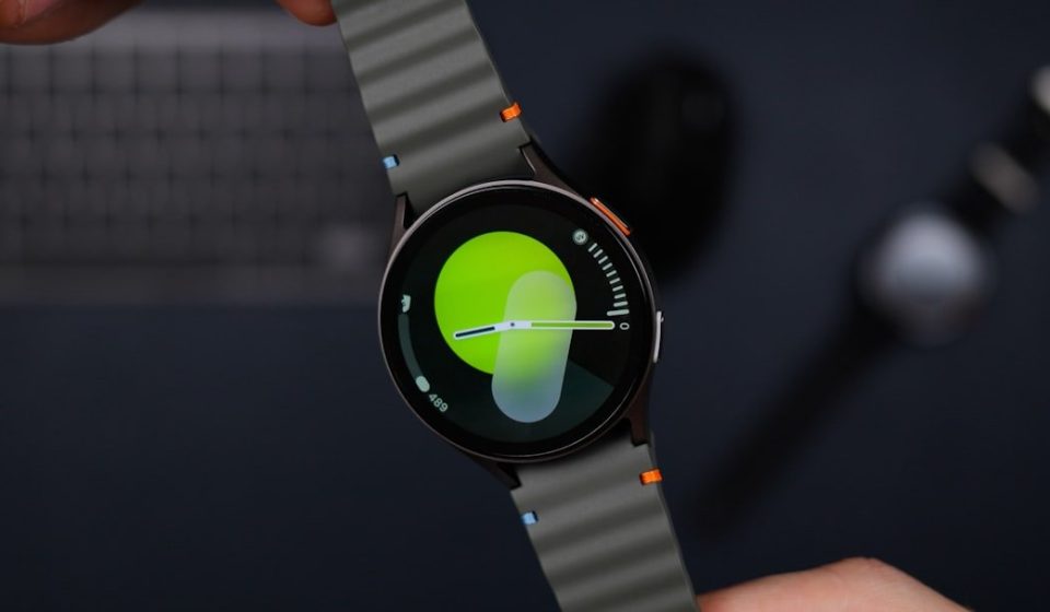A close up of a person holding a smart watch