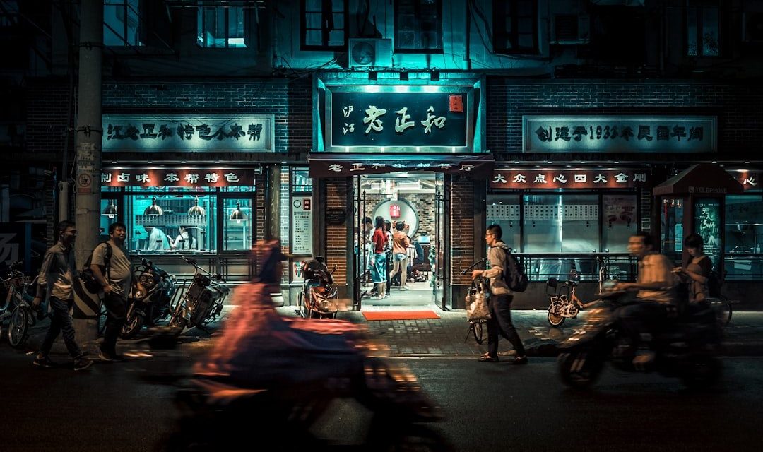 motorcycles and people passing by at night time