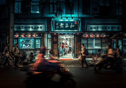 motorcycles and people passing by at night time