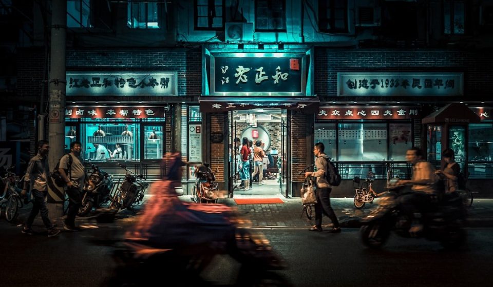 motorcycles and people passing by at night time