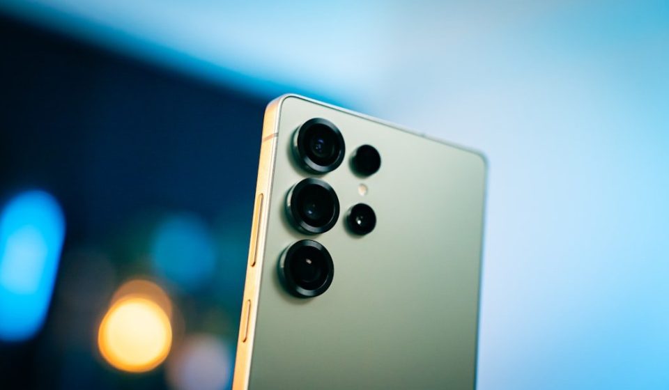 A close up of a cell phone with a blurry background